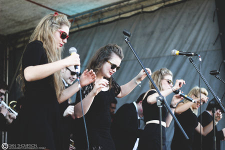 A line of singers dressed in black