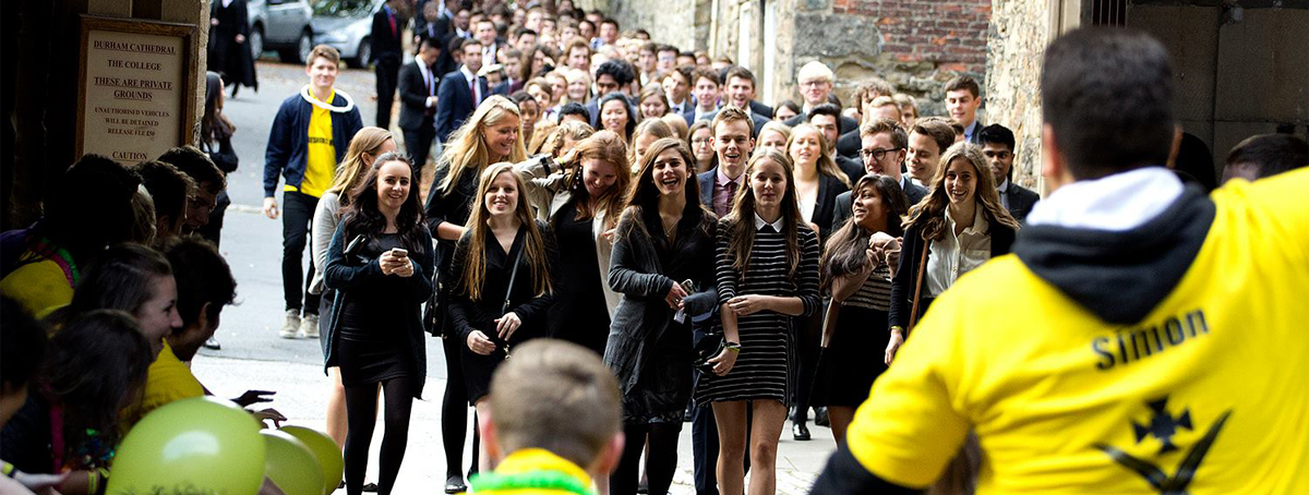 New Mildert students in formal dress matriculating at the cathedral with freps cheering